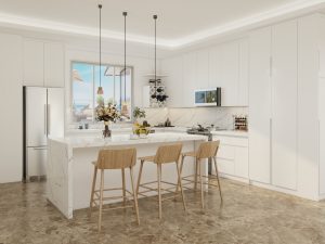 A bright, airy kitchen featuring sleek white cabinets and a spacious marble island, ideal for cooking and socializing.