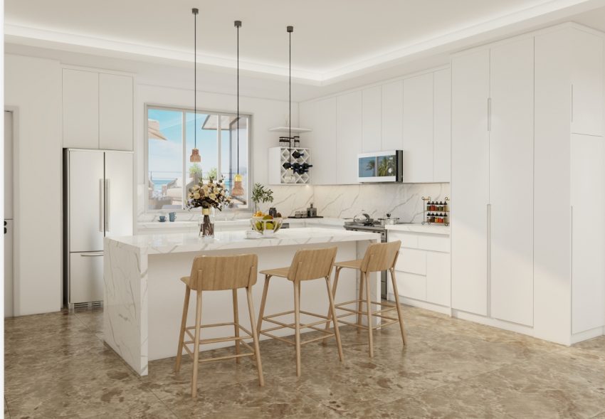 A bright, airy kitchen featuring sleek white cabinets and a spacious marble island, ideal for cooking and socializing.