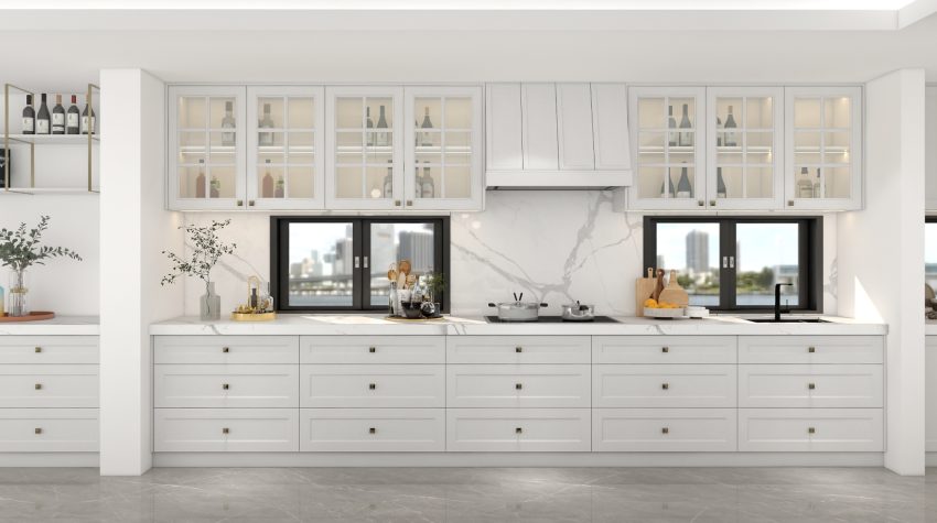 A bright kitchen featuring light plywood cabinets, glass-fronted upper cabinets, and marble countertops, creating a fresh and elegant cooking space.