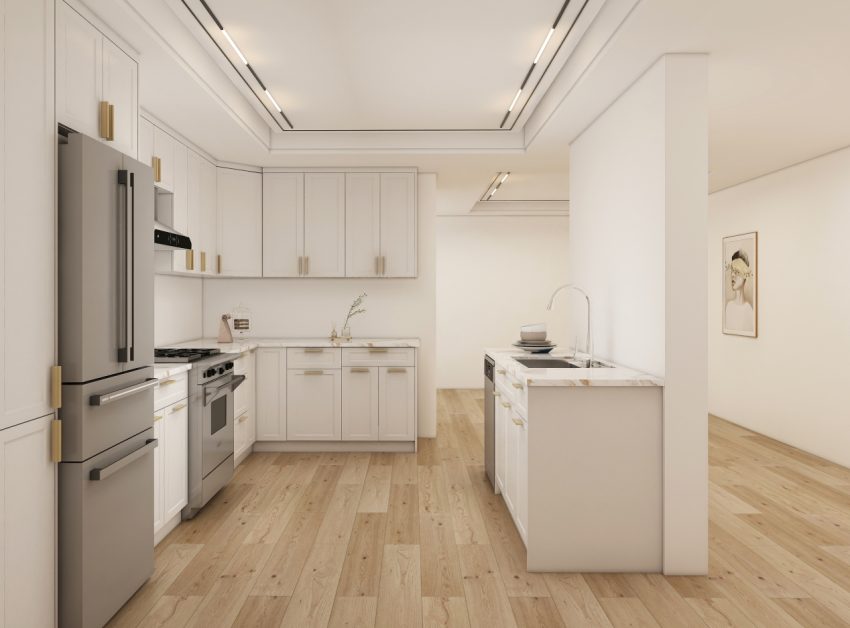 Open and airy kitchen with white shaker cabinets, marble countertops, and light wood flooring