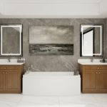 Luxurious bathroom featuring two walnut vanities with white countertops, set against a backdrop of marble walls and centered around a modern bathtub.