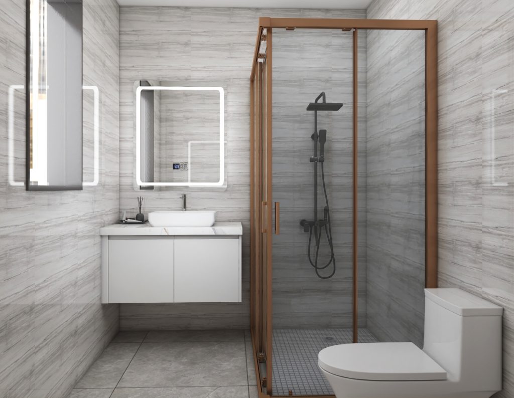 Small white bathroom vanity with a single sink, paired with a compact glass shower and bronze accents, creating a cozy yet modern space.