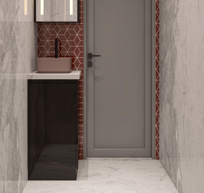 Compact bathroom vanity with sleek black storage and single pink sink.
