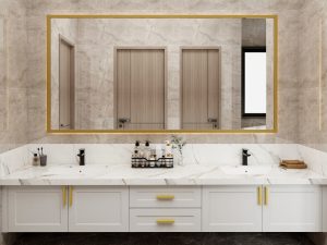 Modern double-sink vanity with a marble countertop, white cabinetry, and gold accents, complemented by a large gold-framed mirror.