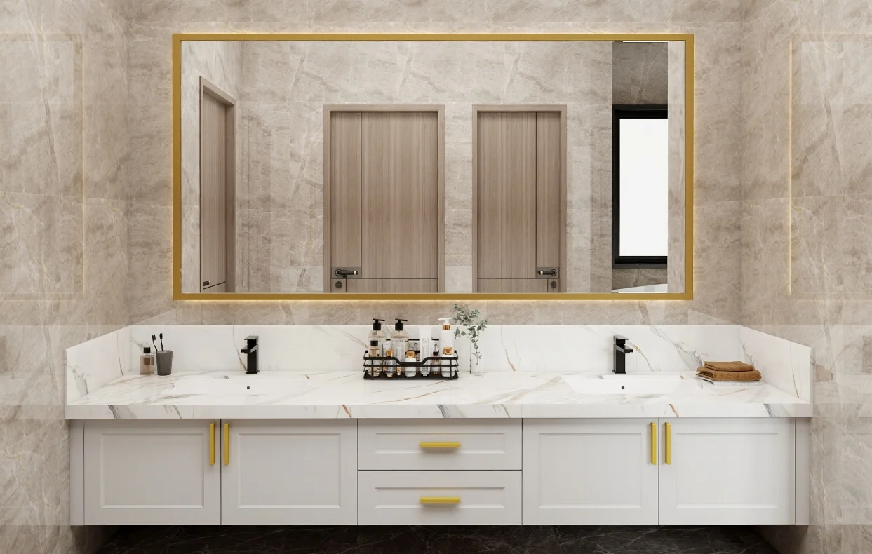 Modern double-sink vanity with a marble countertop, white cabinetry, and gold accents, complemented by a large gold-framed mirror.