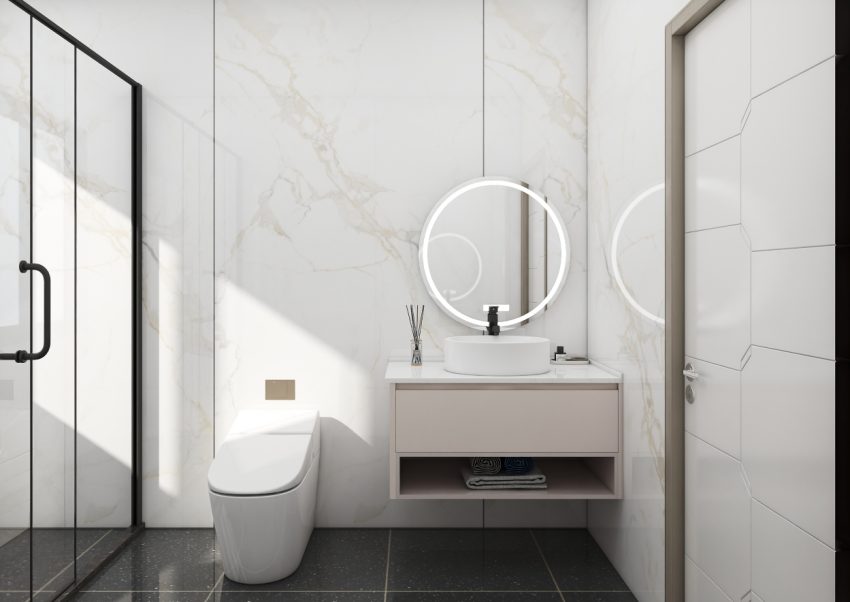 Minimalist bathroom vanity with a round illuminated mirror and light-toned drawer.