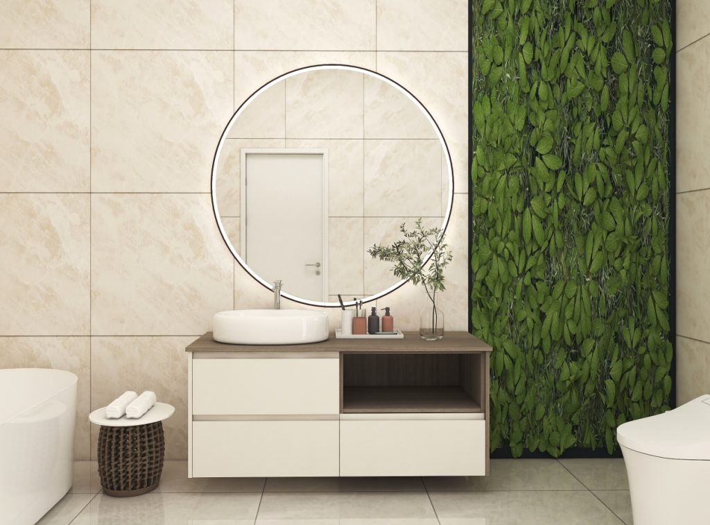 Contemporary bathroom vanity with a wooden surface and white cabinetry, highlighted by a round LED mirror and lush green wall for a natural touch.
