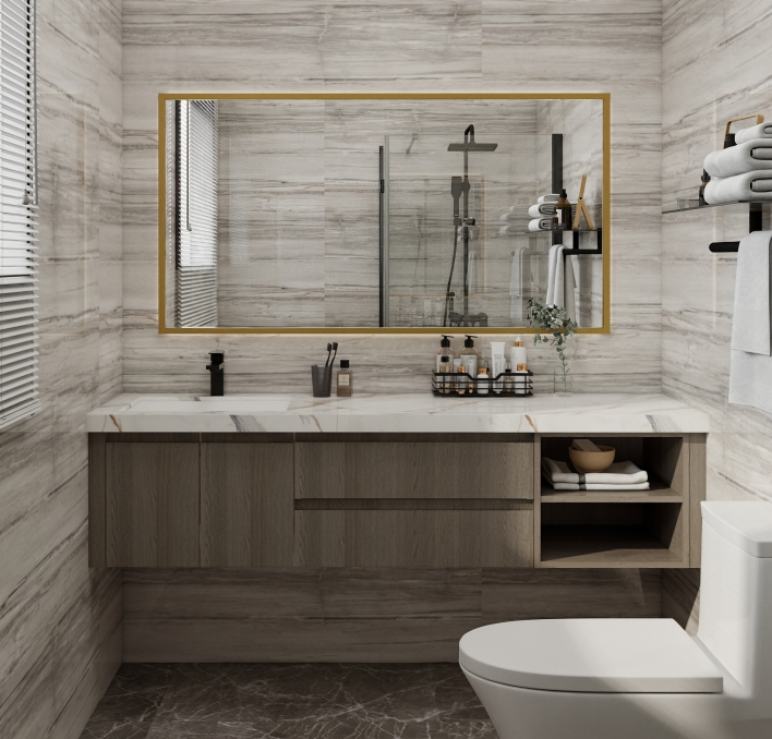 Small bathroom with floating vanity, glass shower, and gold-trimmed mirror.