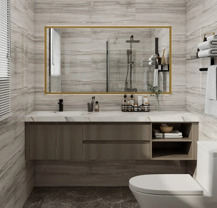 Small bathroom with floating vanity, glass shower, and gold-trimmed mirror.