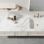 Modern bathroom vanity with marble countertop featuring sleek storage and stylish accessories