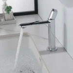 Sleek chrome bathroom faucet with modern design flowing water into a white sink