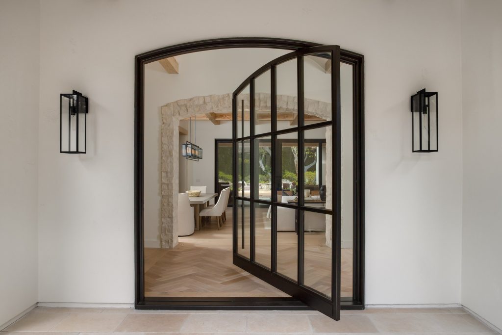 black-aluminum-exterior-pivot-door-with-grids